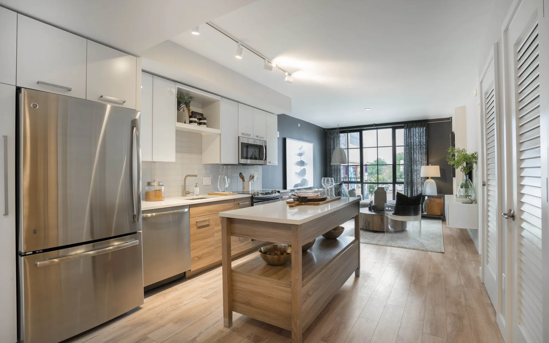 Kitchen with island and view of living room