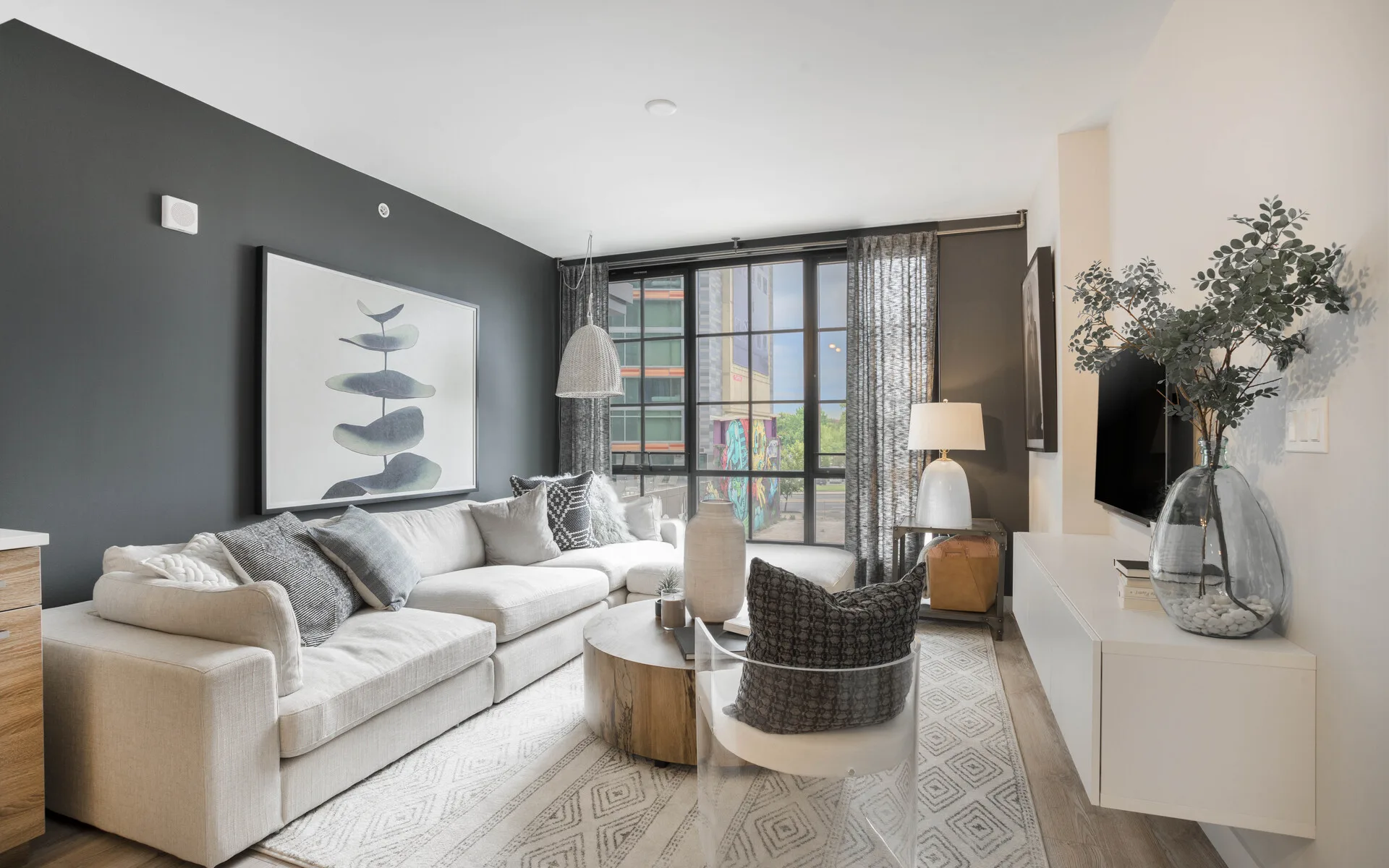 Living room with large couch and floor-to-ceiling windows