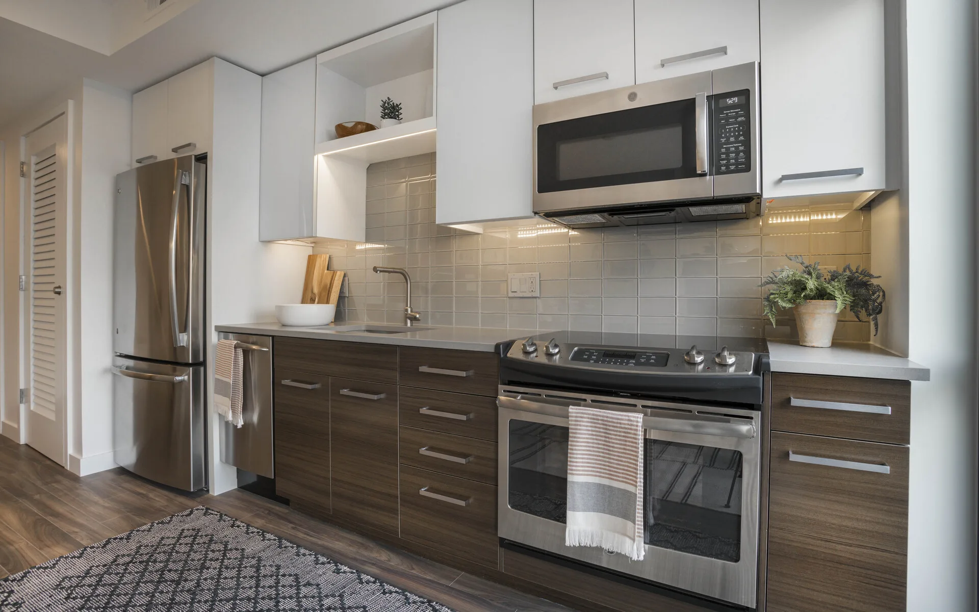 Kitchen with dark cabinets and stainless steel appliances